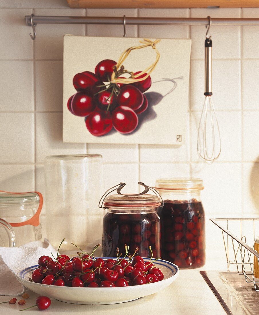 Plate of cherries and two jars of cherry compote