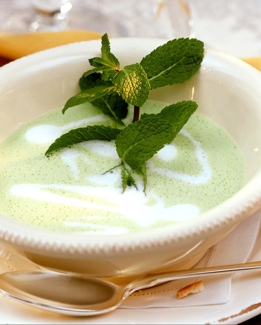 Pea soup with sprig of mint