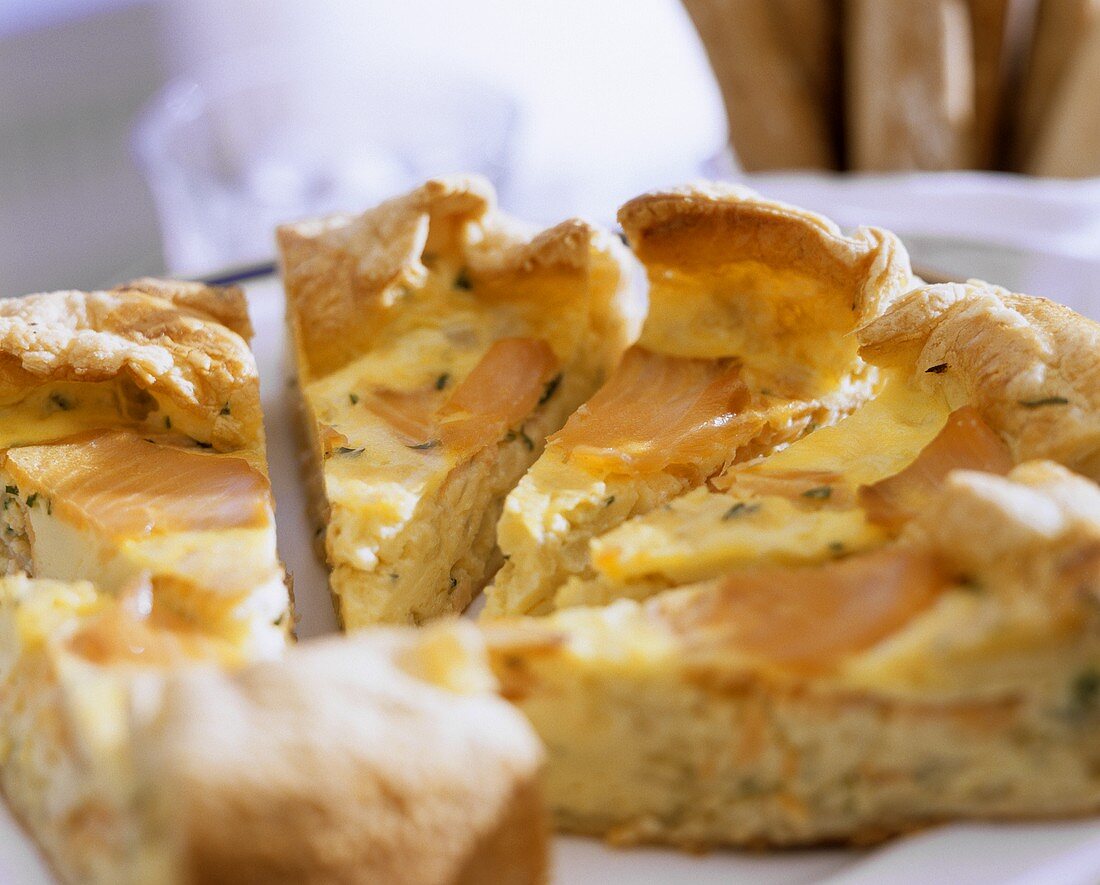 Salmon and herb quiche, cut into several pieces