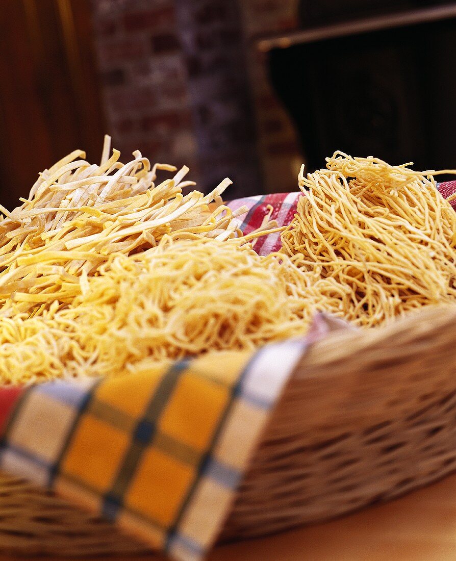 Assorted home-made dried pasta in basket
