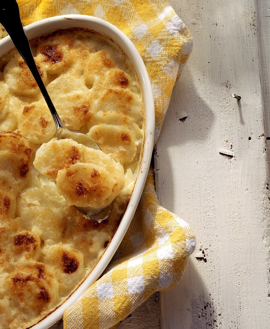 Potato gratin with cheese and a few potatoes on spoon