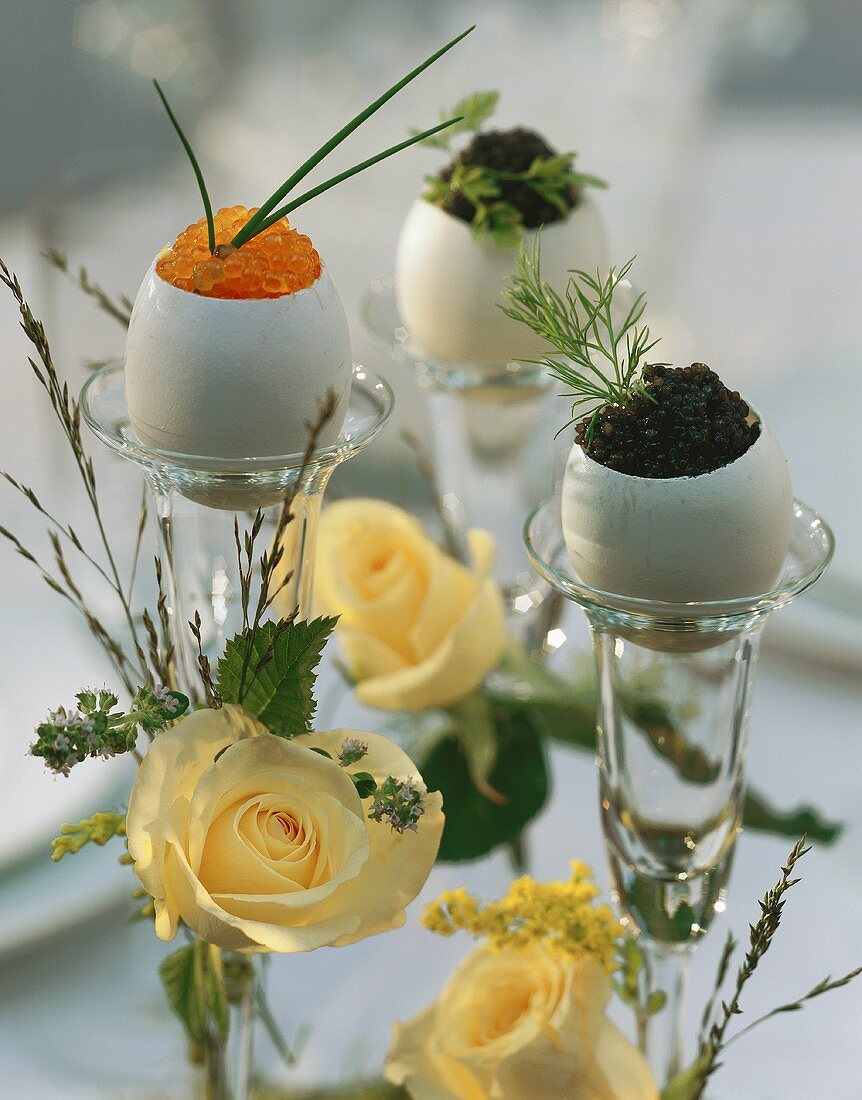 Eggs in their shells filled with caviare on candlesticks
