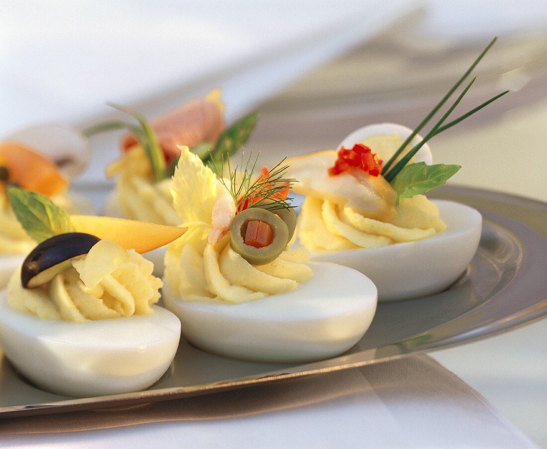 Stuffed eggs with various garnishes on tray