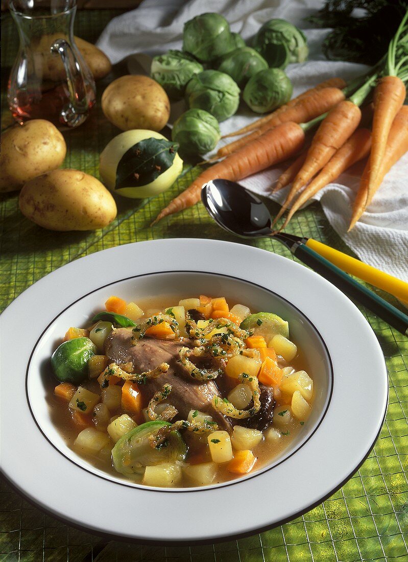 Potato stew with duck legs and Brussels sprouts