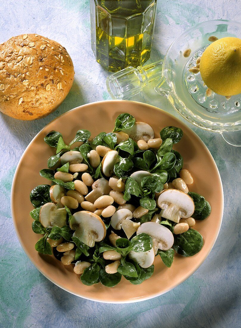 White bean and mushroom salad with corn salad leaves