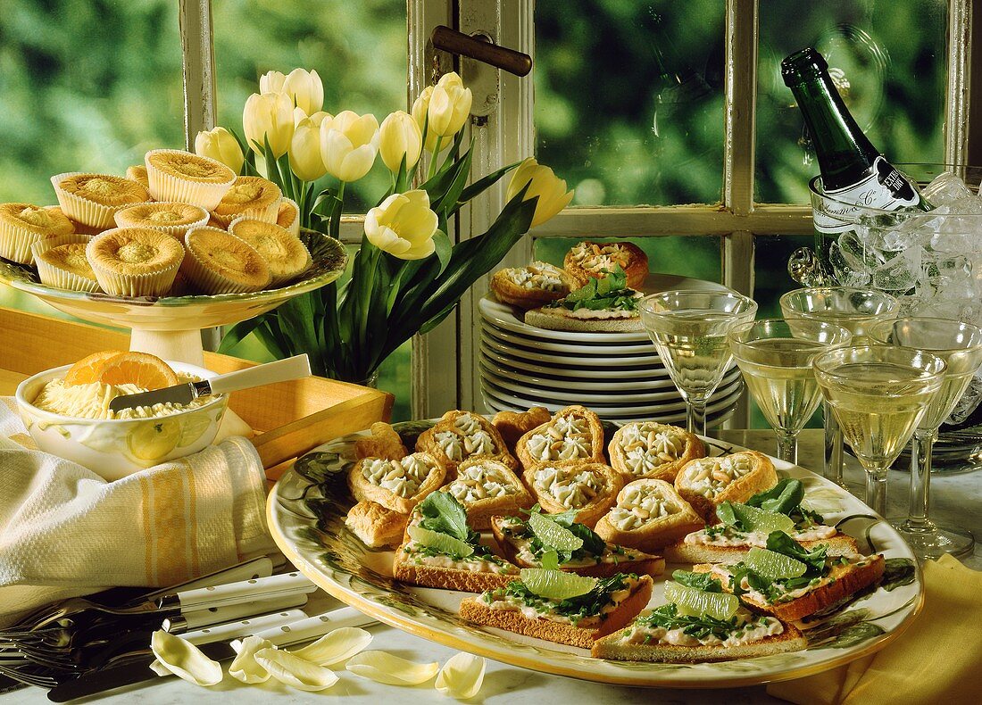 Spring buffet with various snacks, champagne & tulips