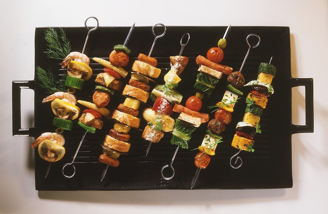 Various kebabs on barbecue rack