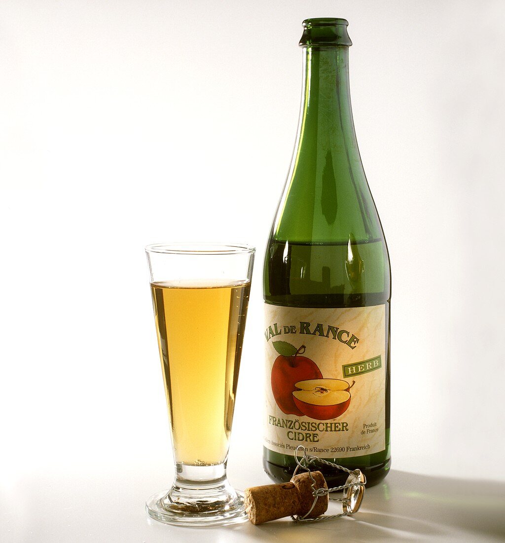 A bottle and a full glass of French cider