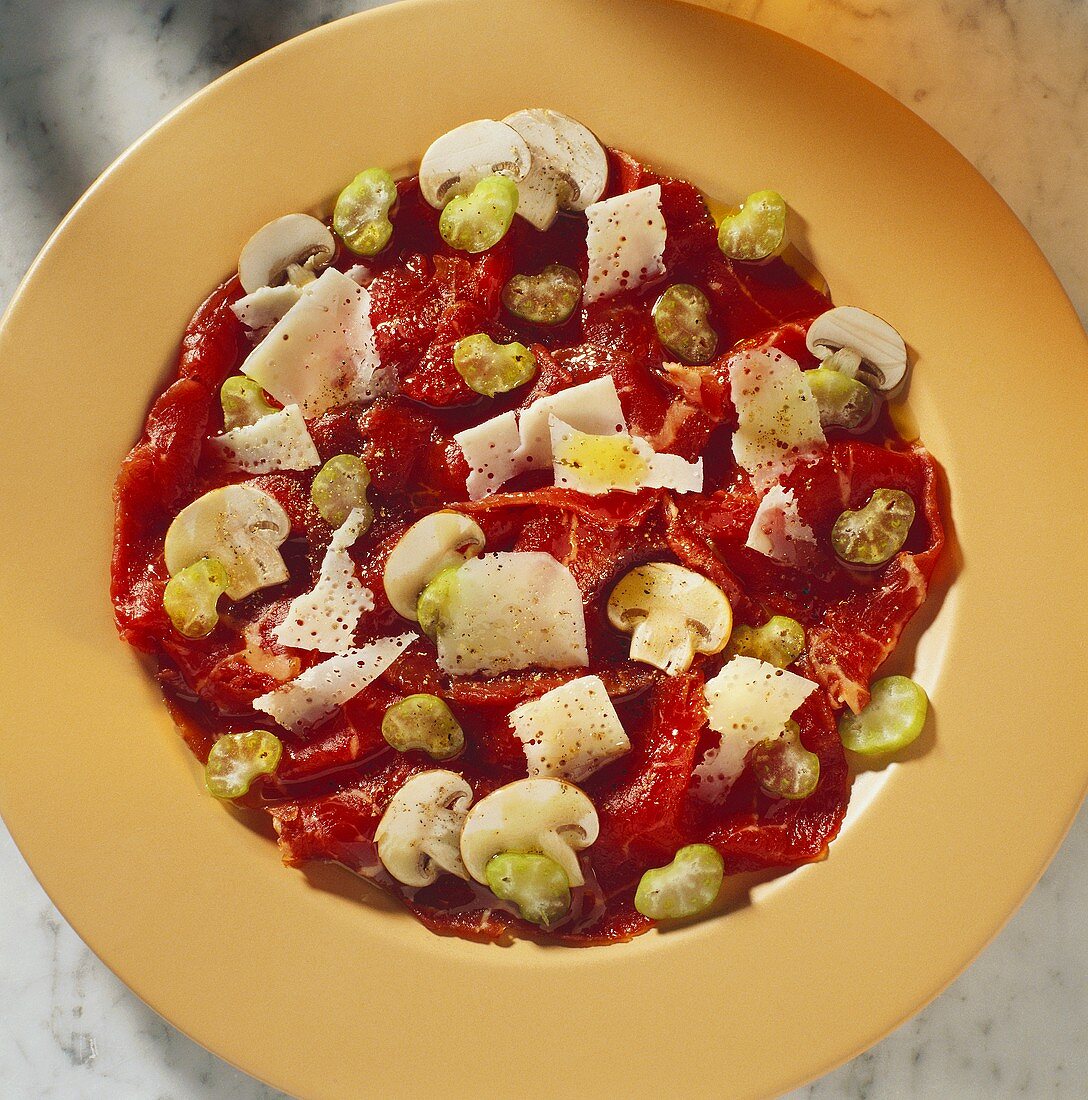 Beef carpaccio with celery, cheese and mushrooms