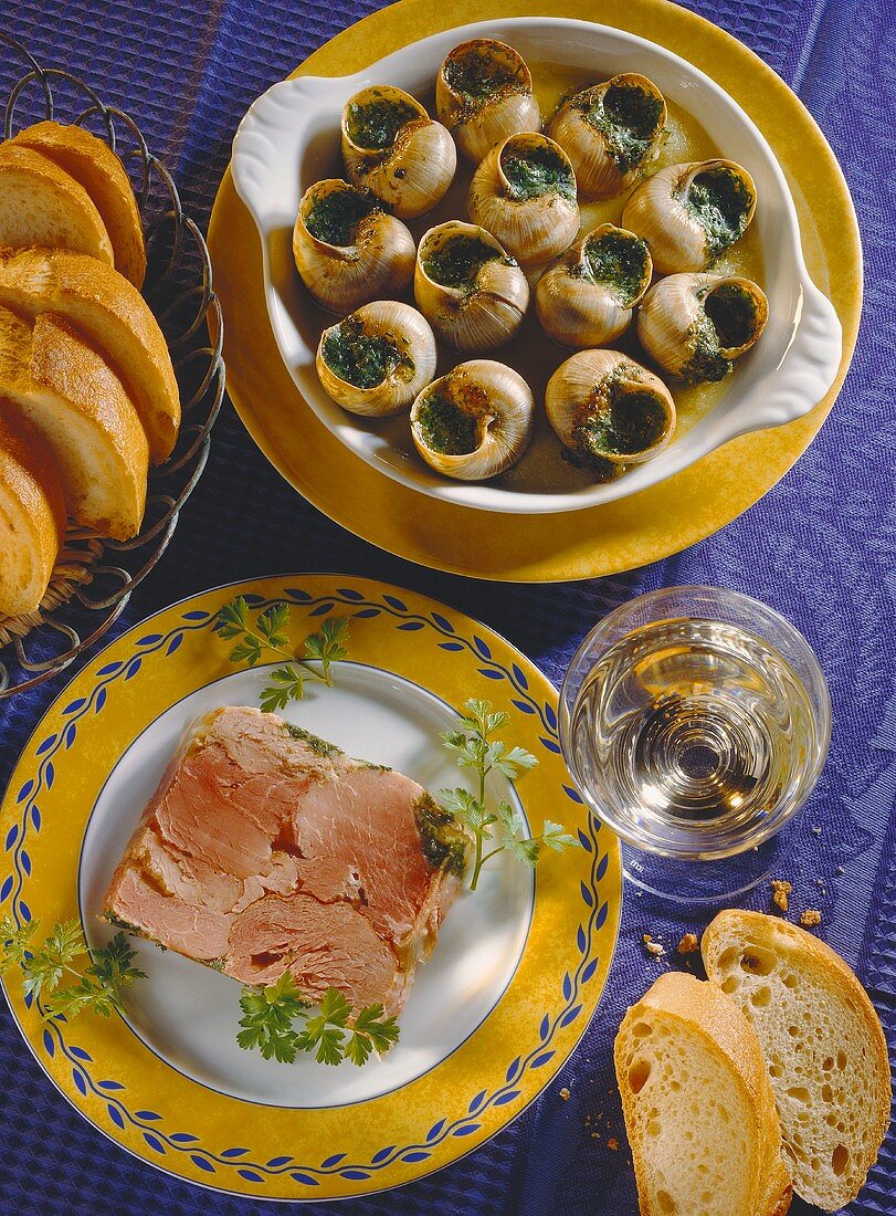 Snails with herb butter and boiled ham in aspic