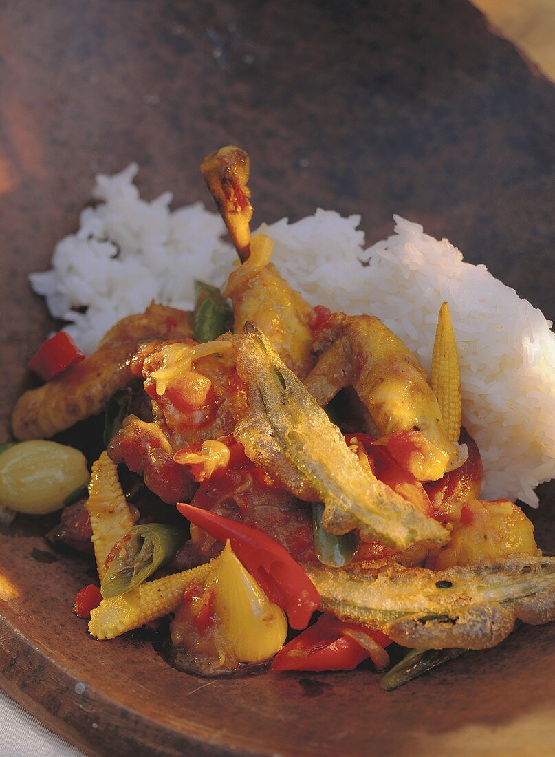 Poussin with deep-fried okra pods, vegetables & rice