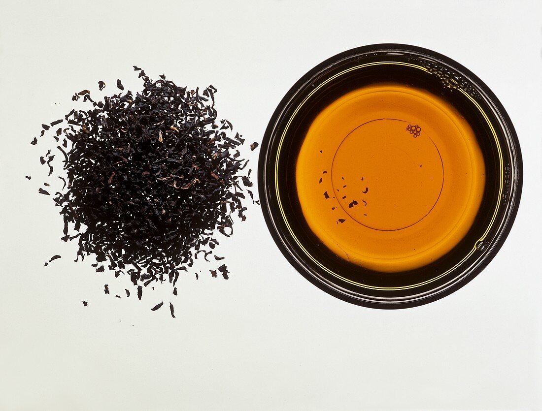 Indian Assam tea; tea leaves and infusion of tea 