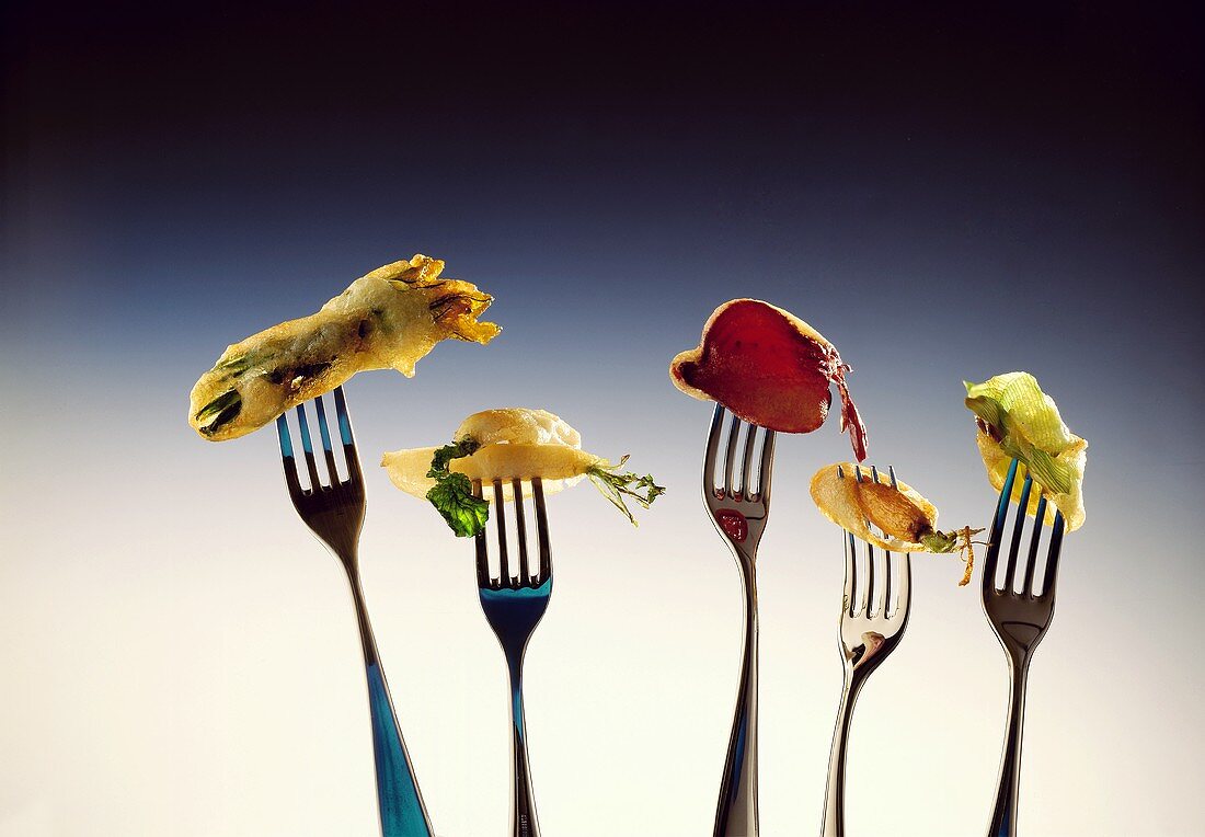 Deep-fried vegetables in beer batter, speared on forks