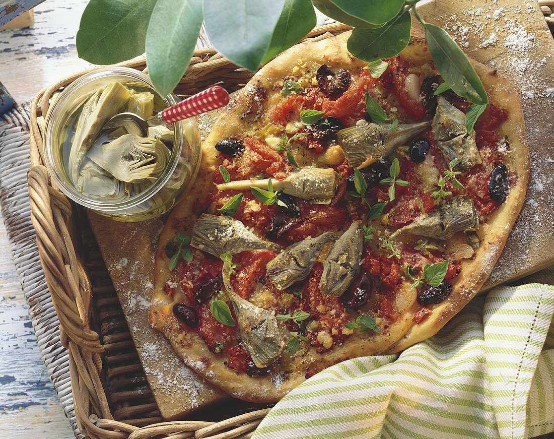 Whole artichoke pizza with tomatoes, olives & fresh oregano