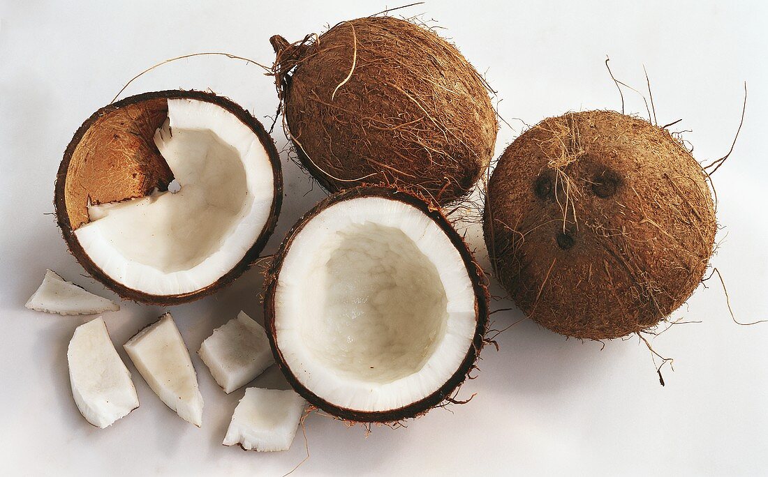 Coconuts, whole and halved and pieces of coconut