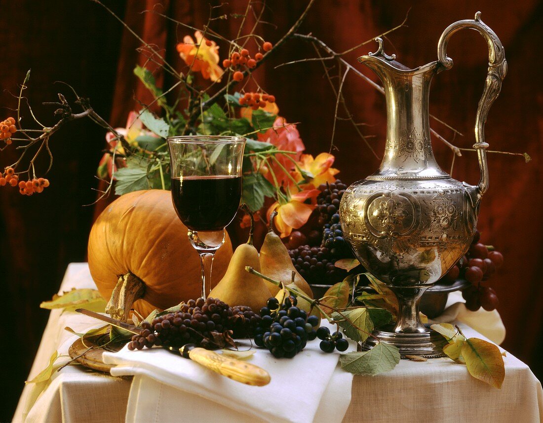 Autumn still life with grapes, pears, pumpkin & red wine