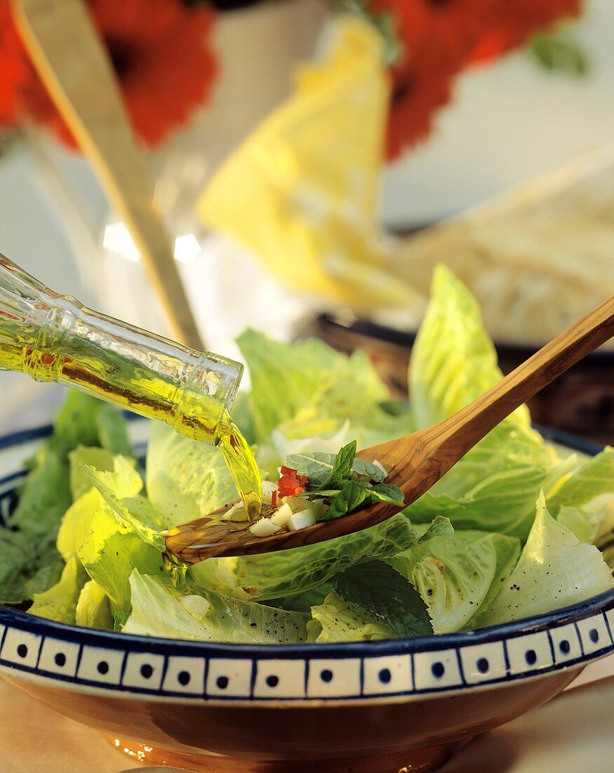 Pouring Dressing on Romaine