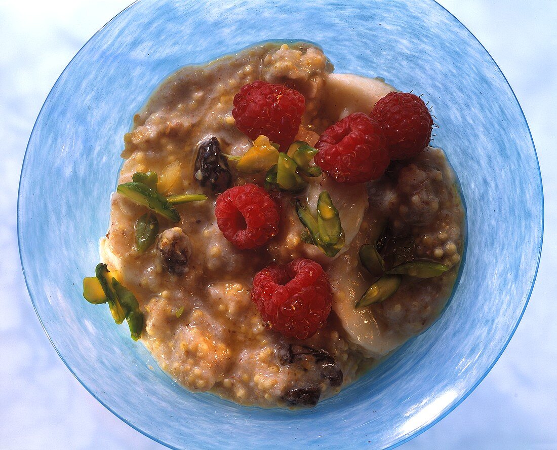 Fresh grain porridge with raspberries, bananas & pistachios