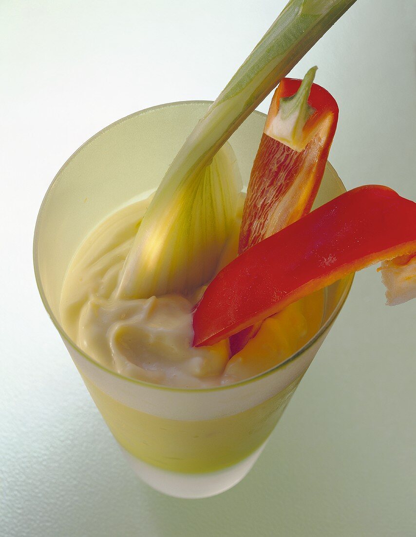 Mayonnaise in beaker with red pepper and celery