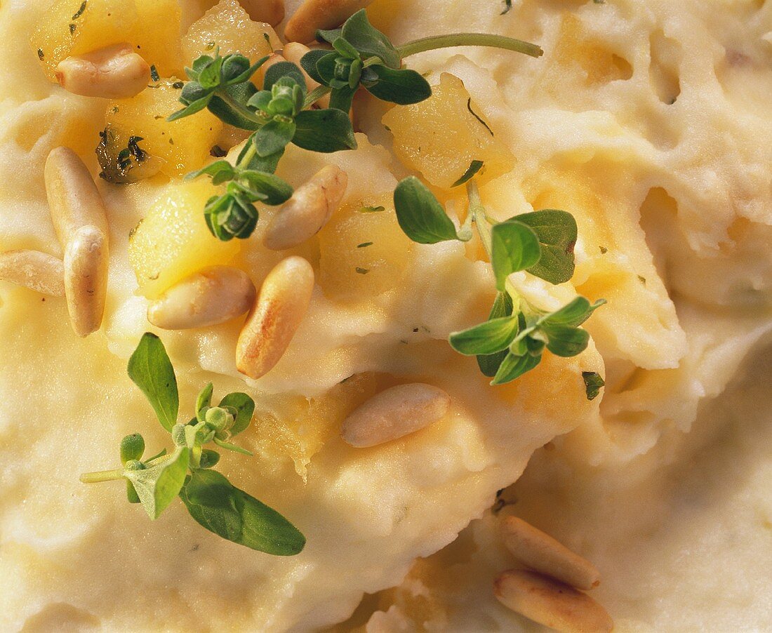 Mashed potato with apples, marjoram, pine nuts (close-up)