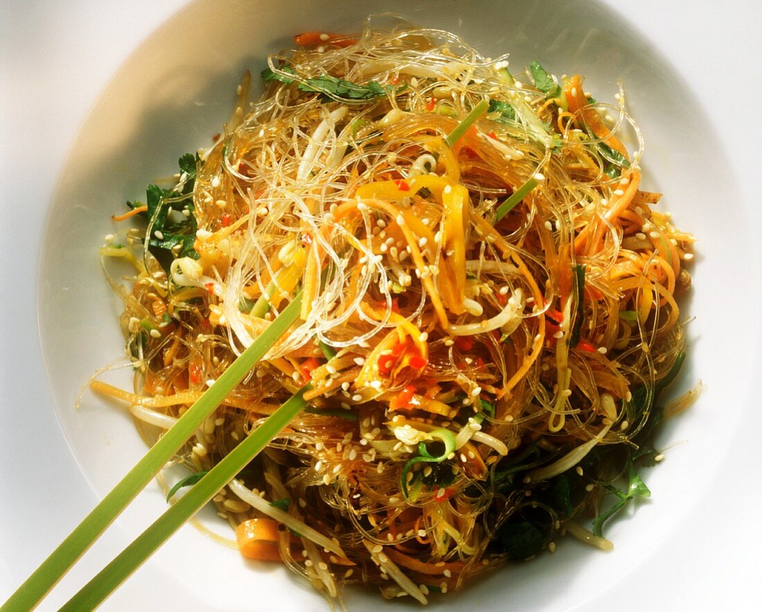 Glass noodles with vegetables & sesame seeds, green chopsticks
