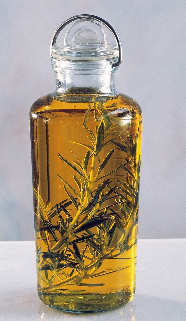 A Bottle of Olive Oil Flavored with Rosemary