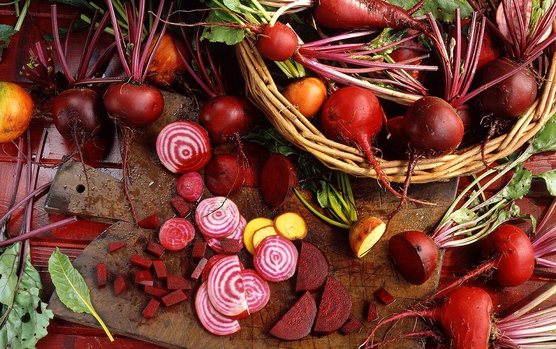 Various types of beetroot in and beside a basket
