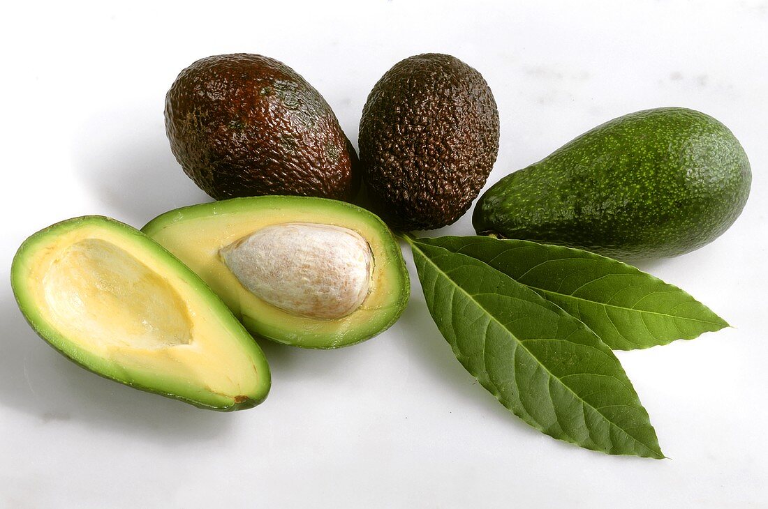 Whole avocados and two avocado halves