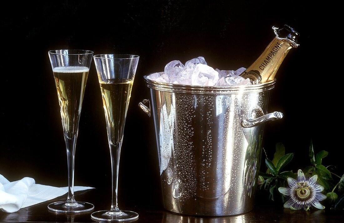 Two Glasses of Champagne with Ice Filled Wine Cooler and Bottle