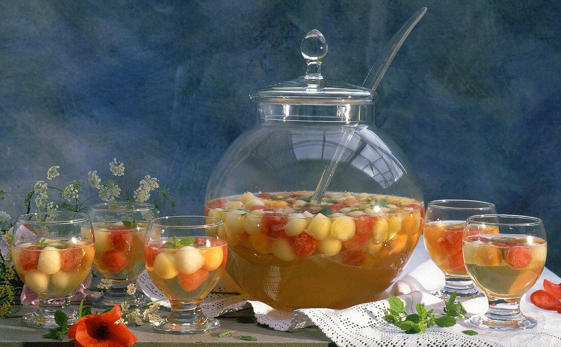 Melon punch in large glass bowl & several glasses
