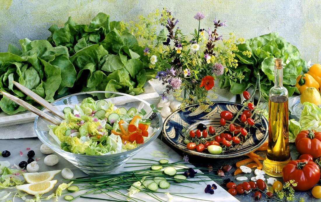 Salad dish & oil, vegetables, herbs, mushrooms, lemon