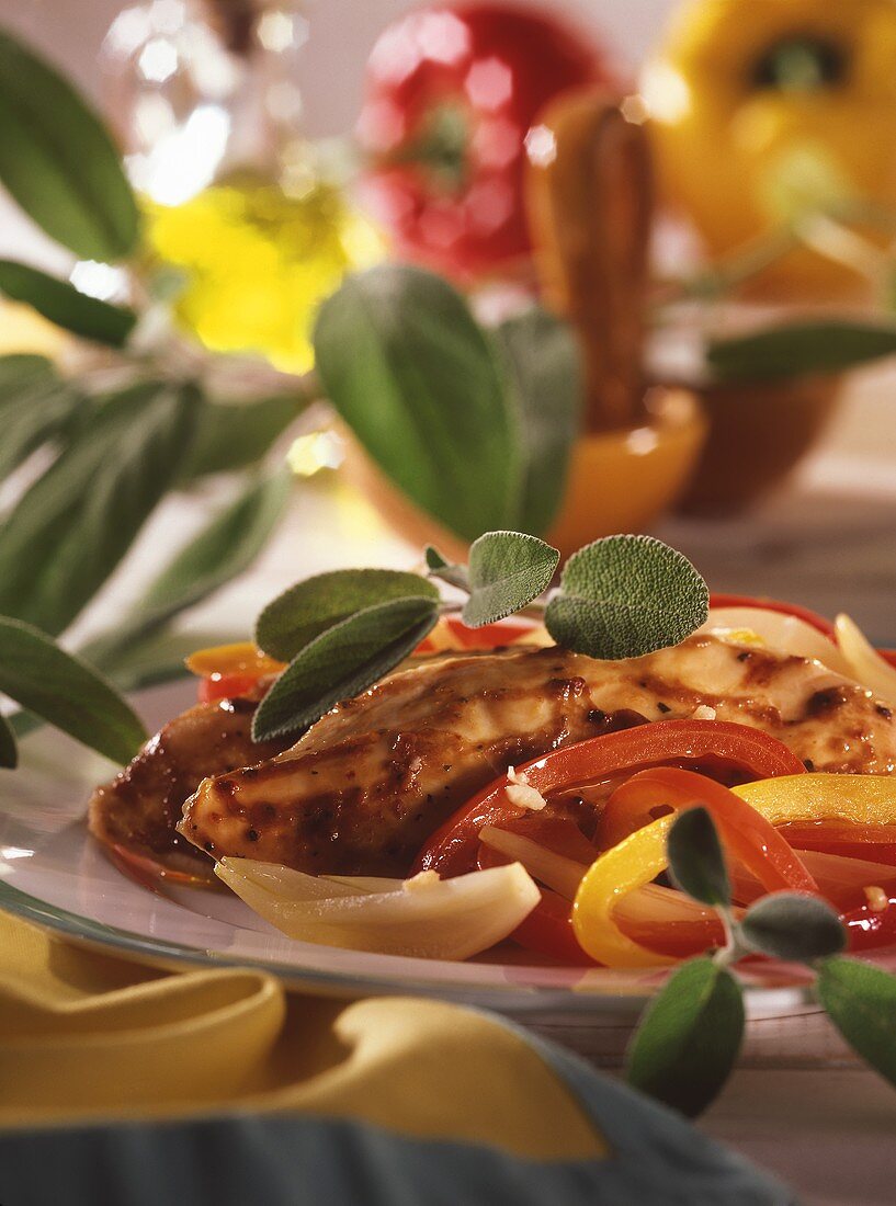 Grilled chicken breast with peppers and sage leaves