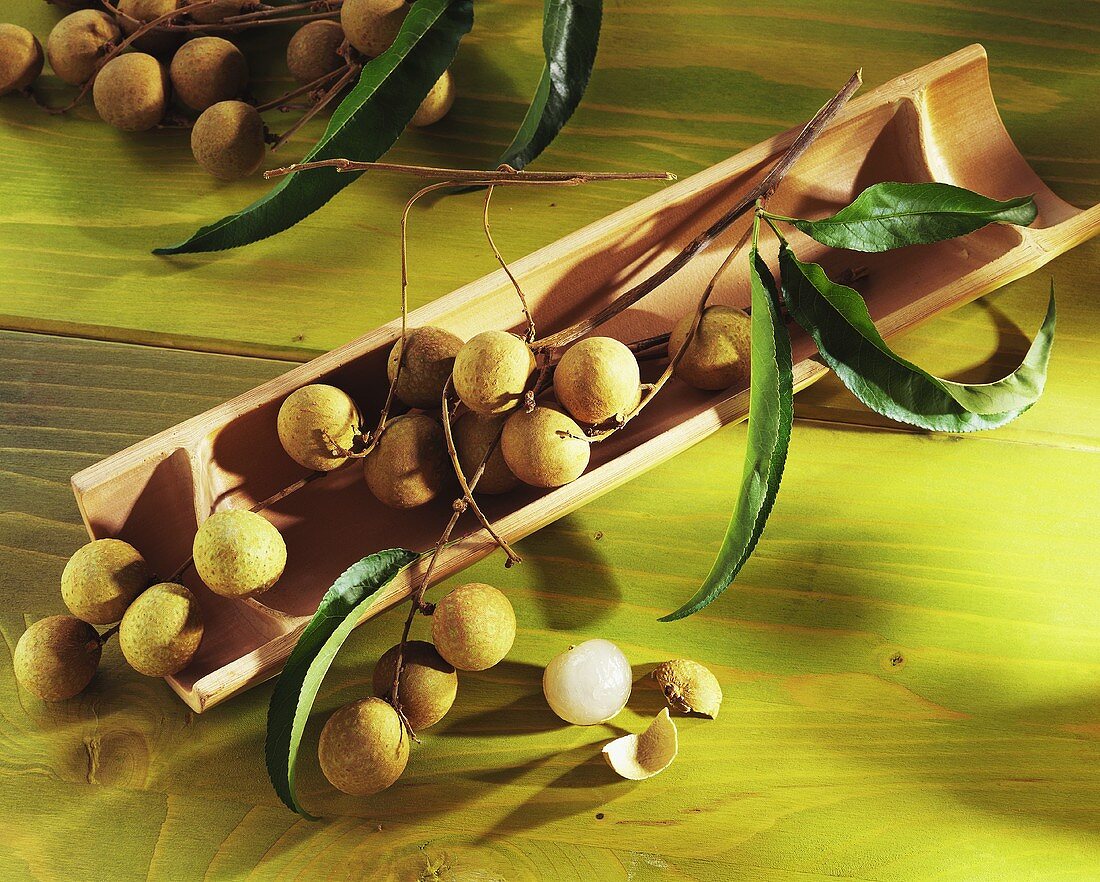 Several longan fruits in a bamboo pipe