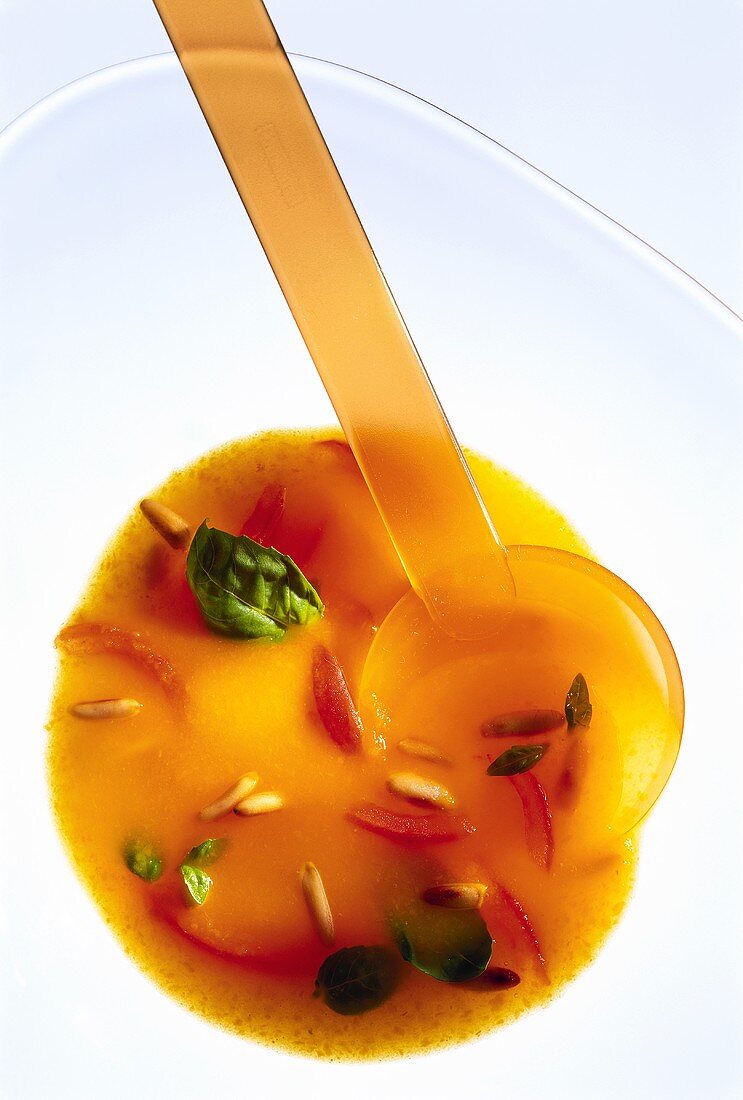 Carrot & orange soup with tomatoes, basil & pine nuts