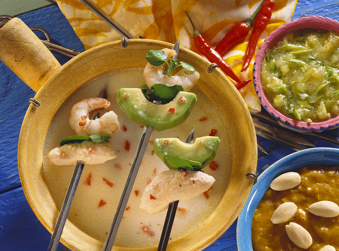 Caribbean coconut fondue with avocado, shrimps, chicken, dips