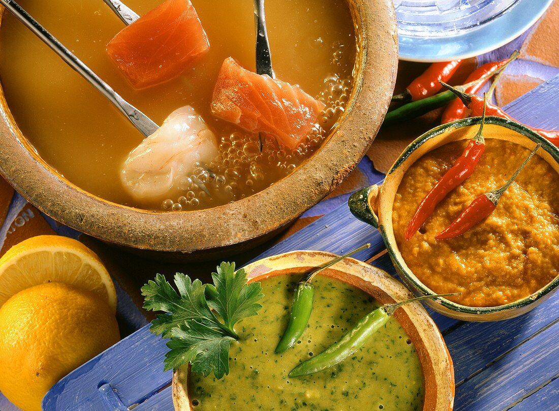 Fish fondue, Canarian style, on forks in hot broth & dips
