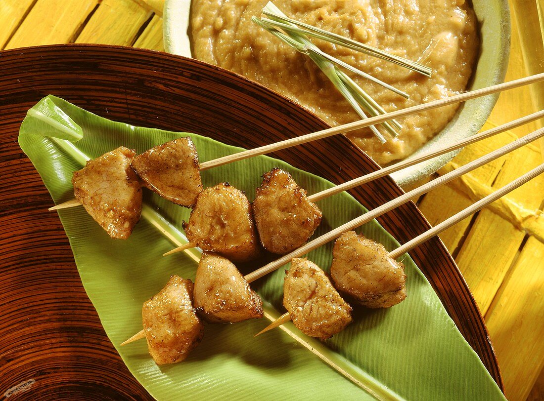 Fondue with satay kebabs on banana leaf & peanut dip