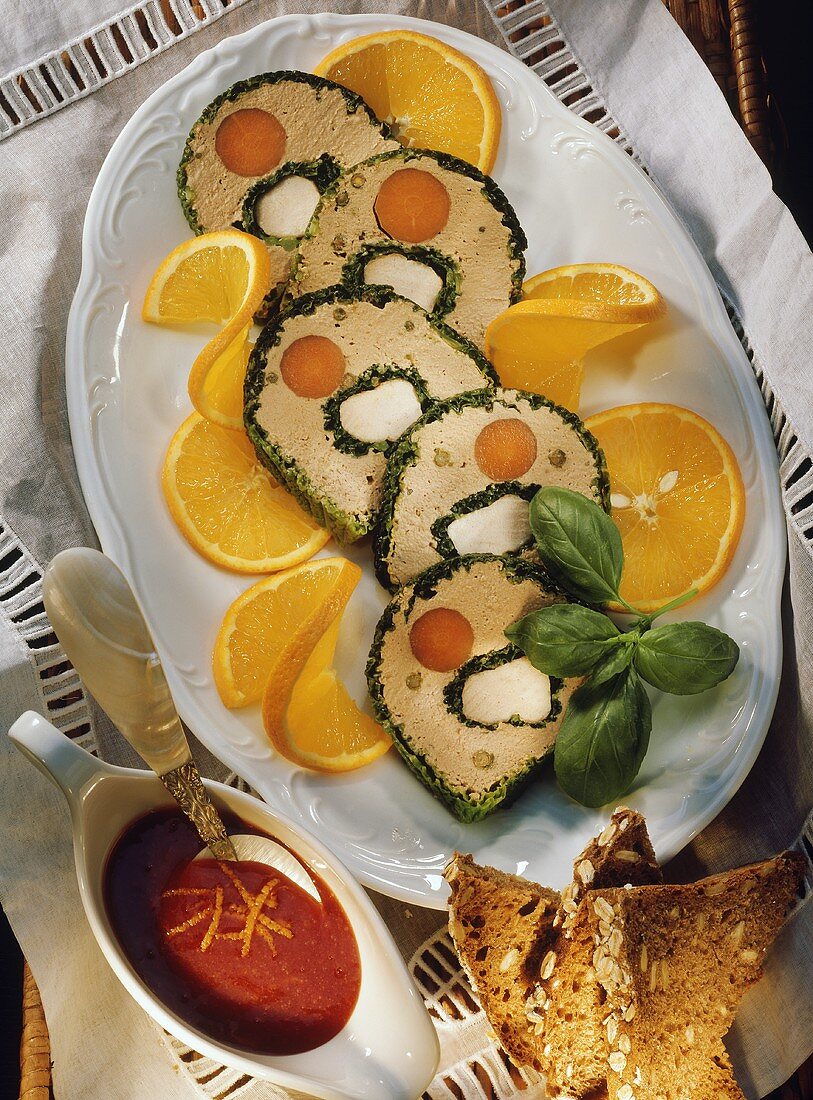 Game terrine (sliced) with oranges, Cumberland sauce, bread