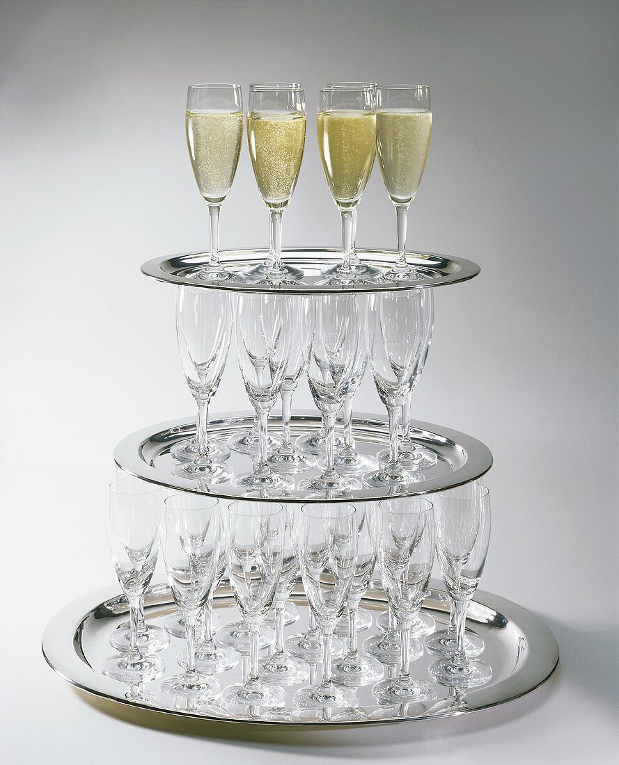 Champagne glasses on trays, three deep