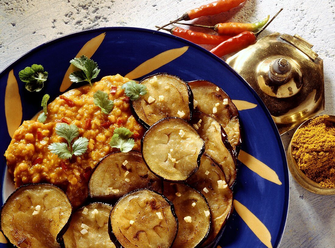 Fried aubergines with garlic and dhal (spicy lentil puree)