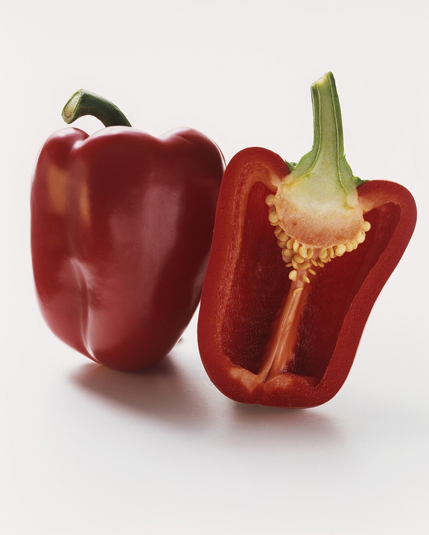Whole and halved red pepper