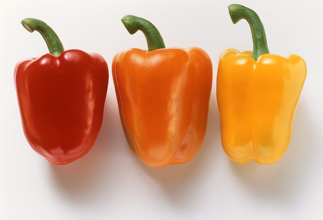 Whole, red, orange and yellow peppers
