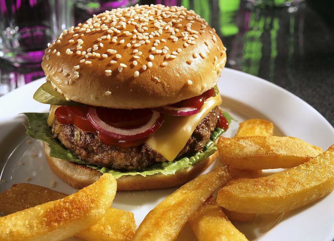 Cheeseburger with tomato, onions, gherkin, fries