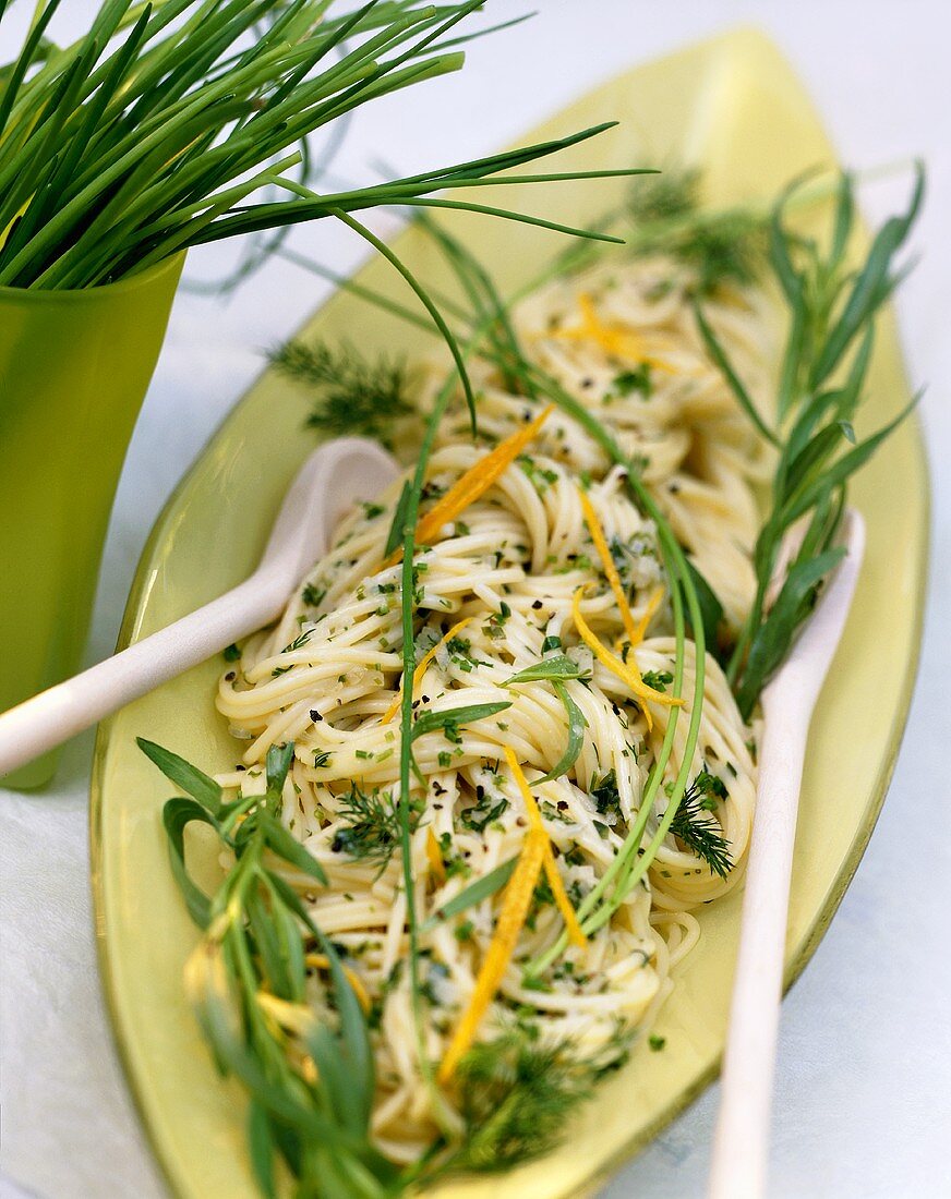 Spaghetti with herb butter and herb leaves