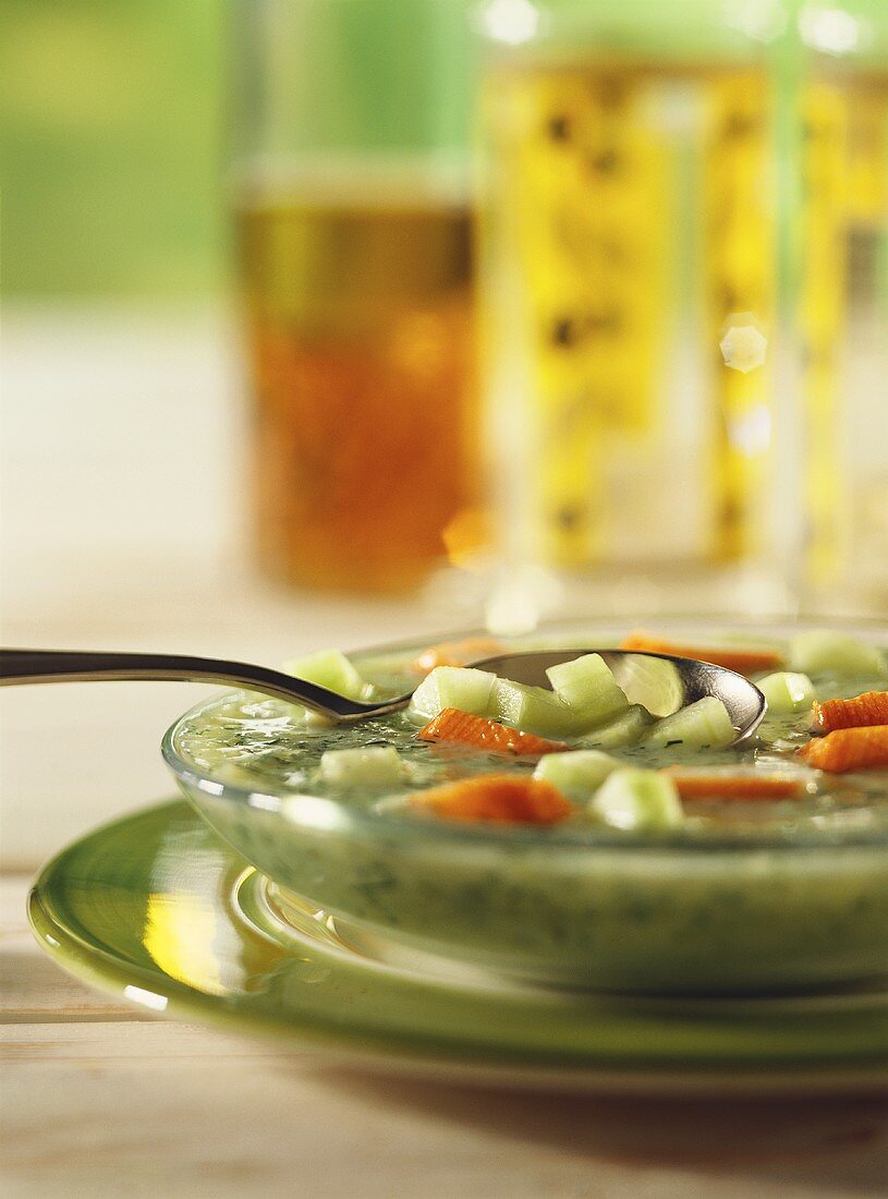 Cold cucumber soup with surimi on soup plate