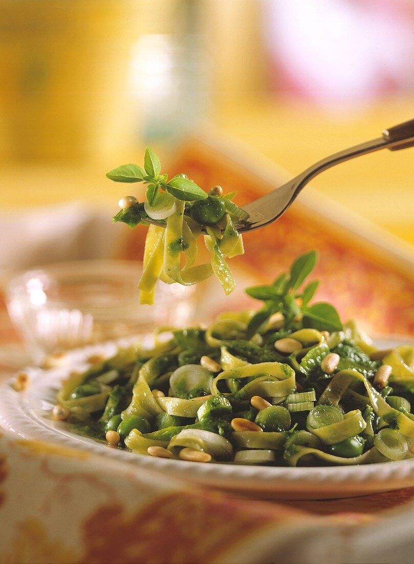 Green ribbon noodle salad with spring onions & pine nuts