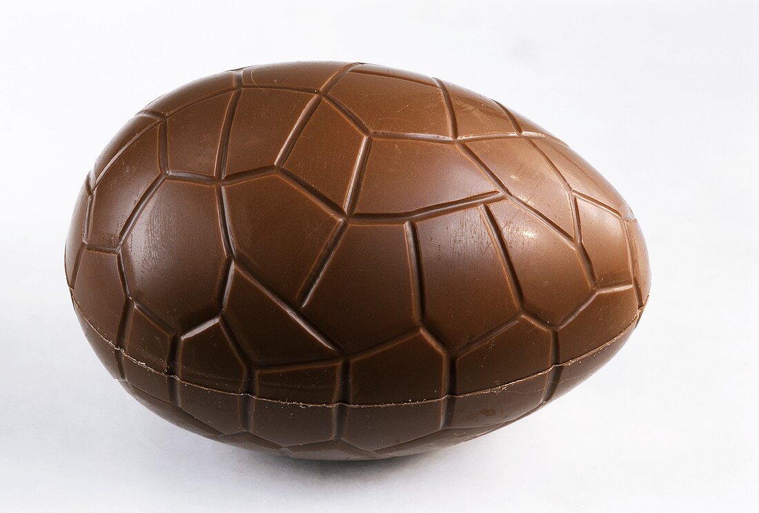 A chocolate egg on light-coloured background