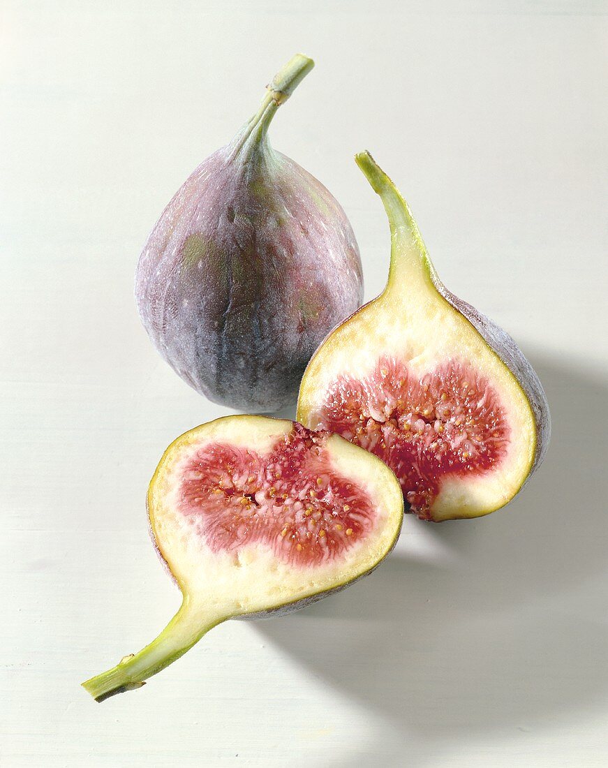 Two fresh figs, one halved