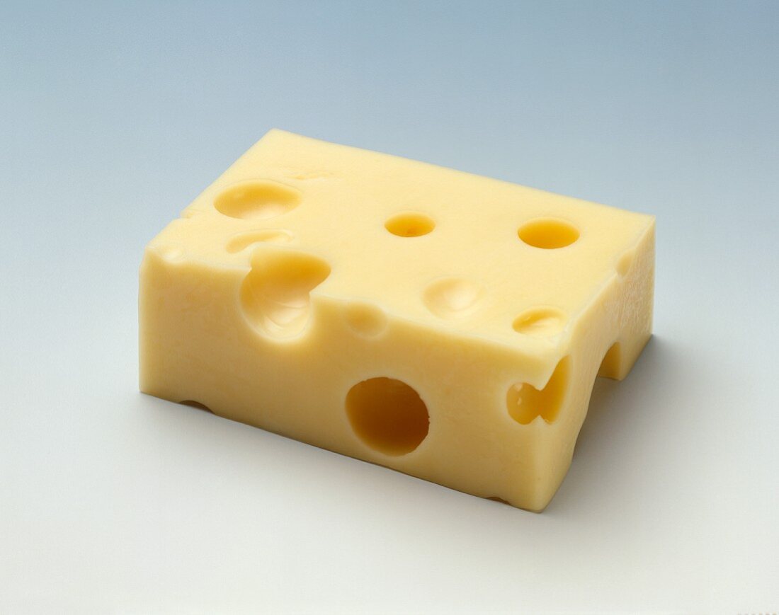 Emmental cheese (rectangular piece) on light background
