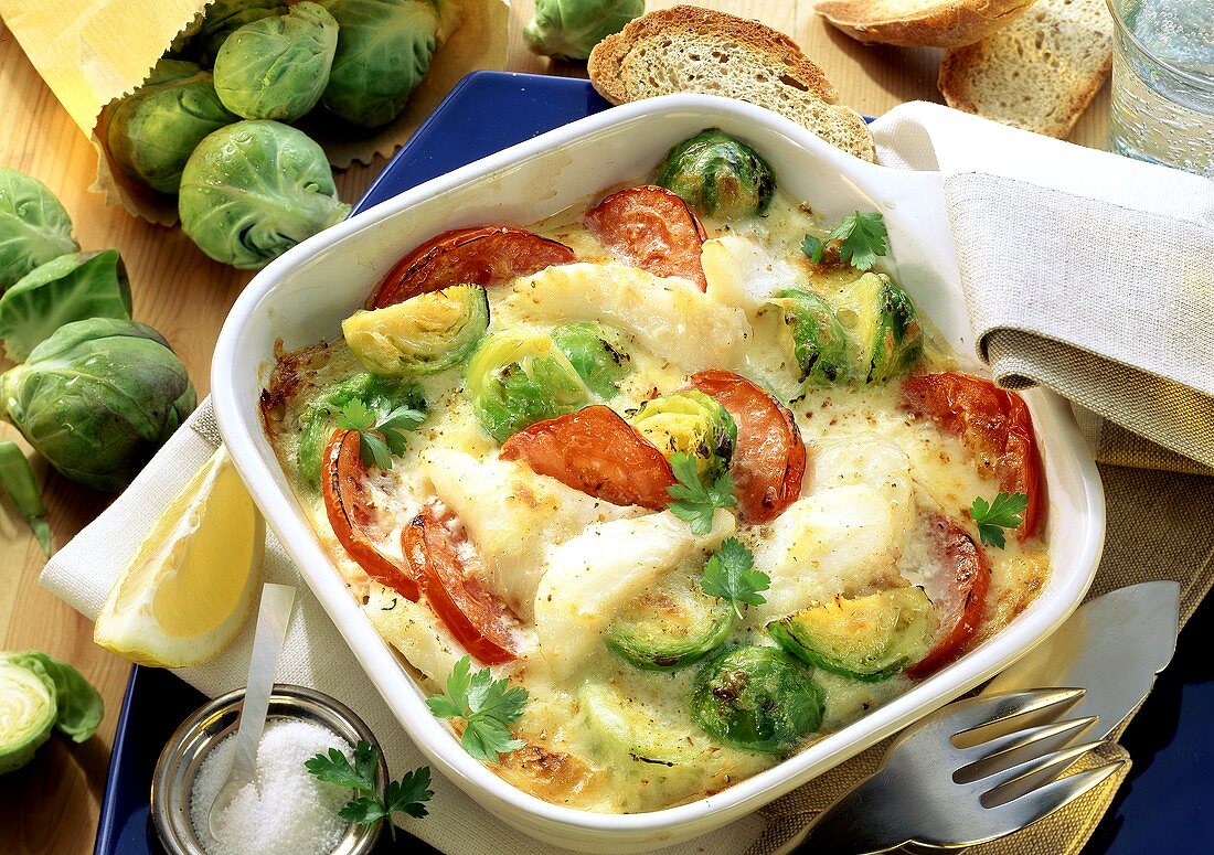 Brussels sprout gratin with fish fillet & tomatoes in dish